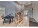 Elegant foyer with a curved staircase, a baby grand piano, and stylish tile flooring at 193 Glenbrook Estates Dr, Las Vegas, NV 89183