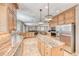 Open kitchen with granite countertops, a central island, and views into the dining and living areas at 193 Glenbrook Estates Dr, Las Vegas, NV 89183