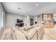 Comfortable living room with a large sectional sofa, TV, and access to the kitchen area at 193 Glenbrook Estates Dr, Las Vegas, NV 89183