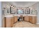 Main bathroom featuring a vanity with dual sinks, a makeup table, and warm wood cabinetry at 193 Glenbrook Estates Dr, Las Vegas, NV 89183
