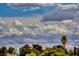 Scenic mountain view from property showcasing Nevada landscape, trees, and blue skies with dramatic cloudscape at 193 Glenbrook Estates Dr, Las Vegas, NV 89183