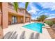 A refreshing swimming pool is nestled next to a two-story home with a balcony and covered patio at 193 Glenbrook Estates Dr, Las Vegas, NV 89183