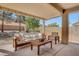 Comfortable covered patio with elegant wooden furniture, perfect for outdoor relaxation at 2099 Desert Woods Dr, Henderson, NV 89012