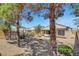 Large backyard features a fire pit, desert landscaping, and a covered patio with outdoor seating at 2099 Desert Woods Dr, Henderson, NV 89012
