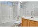 Tile floor bathroom with combination bathtub/shower, wood vanity and sink at 2099 Desert Woods Dr, Henderson, NV 89012