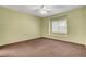 Spacious carpeted bedroom features a ceiling fan and a large window for natural light at 2099 Desert Woods Dr, Henderson, NV 89012