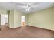 Spacious carpeted bedroom featuring fan, and multiple doors at 2099 Desert Woods Dr, Henderson, NV 89012