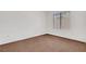 An empty room with brown carpet and a window covered by blinds at 2099 Desert Woods Dr, Henderson, NV 89012