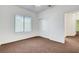 Bedroom featuring plush carpet, a large window, and a double-door closet at 2099 Desert Woods Dr, Henderson, NV 89012