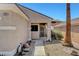 Welcoming front porch with a security gate, desert landscaping, and exterior lighting at 2099 Desert Woods Dr, Henderson, NV 89012