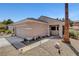 Desert-style home with a two-car garage, drought-tolerant landscaping, and walkway lighting at 2099 Desert Woods Dr, Henderson, NV 89012