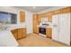 A corner of the kitchen showing the appliances, cabinets, countertop, and tile floor at 2099 Desert Woods Dr, Henderson, NV 89012