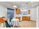 Bright kitchen area featuring tile floors, wood cabinets, stainless steel appliances and dining table at 2099 Desert Woods Dr, Henderson, NV 89012