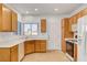 Bright kitchen featuring white appliances, wooden cabinets, and a tiled floor at 2099 Desert Woods Dr, Henderson, NV 89012