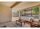 Inviting covered patio features comfortable seating, perfect for outdoor relaxation and entertaining at 2099 Desert Woods Dr, Henderson, NV 89012