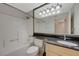 Clean bathroom with a tub-shower combination and a vanity with granite countertop at 210 E Flamingo Rd # 105, Las Vegas, NV 89169