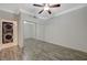 Bedroom with hardwood floors, ceiling fan, and mirrored closet doors at 210 E Flamingo Rd # 105, Las Vegas, NV 89169