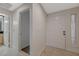 Welcoming entryway features tile flooring, neutral paint, and sidelight window at 210 E Flamingo Rd # 105, Las Vegas, NV 89169
