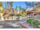 Gated entrance with lush landscaping offering security and privacy to residents at 210 E Flamingo Rd # 105, Las Vegas, NV 89169