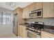 Well-equipped kitchen featuring stainless steel appliances and bright cabinets with lots of room for food storage at 210 E Flamingo Rd # 105, Las Vegas, NV 89169