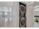 Hallway laundry area with stackable washer/dryer at 210 E Flamingo Rd # 105, Las Vegas, NV 89169