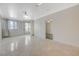Spacious living room with light tile flooring, neutral walls, and natural light at 210 E Flamingo Rd # 105, Las Vegas, NV 89169