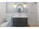 Elegant bathroom features modern vanity with double sinks, subway tile and unique round mirror at 2205 Sombrero Dr, Las Vegas, NV 89169