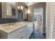 Elegant bathroom with marble counters, double sinks, large mirror and stylish lighting fixtures at 2205 Sombrero Dr, Las Vegas, NV 89169