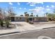 Charming single-story home showcasing xeriscaping, palm trees and a turquoise front door at 2205 Sombrero Dr, Las Vegas, NV 89169