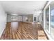 Open living room featuring hardwood floors, a fireplace, and a backyard pool view at 2205 Sombrero Dr, Las Vegas, NV 89169