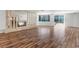 Bright living room featuring hardwood floors, a fireplace, and large windows overlooking the backyard at 2205 Sombrero Dr, Las Vegas, NV 89169