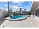 Beautiful pool with a rock waterslide feature surrounded by vibrant desert landscaping at 2205 Sombrero Dr, Las Vegas, NV 89169