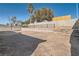 Large backyard offering a blank canvas with desert landscaping, surrounded by sturdy block walls for privacy at 239 Eugene Way, Henderson, NV 89015