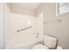 Clean, white tiled tub and shower combination in a well-lit bathroom featuring grab bars and a neutral color palette at 239 Eugene Way, Henderson, NV 89015
