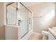 Bathroom featuring a tiled shower with glass door and a white vanity with sink and toilet at 239 Eugene Way, Henderson, NV 89015