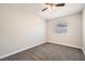 Cozy bedroom with neutral carpet, ceiling fan, and a window providing natural light and a peaceful ambiance at 239 Eugene Way, Henderson, NV 89015