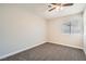 Neutrally decorated bedroom with plush carpet, ceiling fan, and a window providing natural light at 239 Eugene Way, Henderson, NV 89015