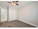 Bedroom featuring neutral carpet, ceiling fan, and closet with door and access to other rooms at 239 Eugene Way, Henderson, NV 89015