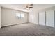 Large bedroom features plush carpet, ceiling fan, and closet with sliding doors offering ample storage at 239 Eugene Way, Henderson, NV 89015