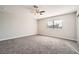 Spacious bedroom with neutral carpet, a ceiling fan, and a window allowing ample natural light at 239 Eugene Way, Henderson, NV 89015