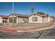 Single-story home featuring a two-car garage, desert landscaping, and block perimeter fence at 239 Eugene Way, Henderson, NV 89015