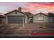 Charming single-story home with a two-car garage, low maintenance desert landscaping, and an inviting facade at 239 Eugene Way, Henderson, NV 89015