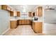 Functional kitchen featuring wood cabinets, neutral countertops, and essential appliances at 239 Eugene Way, Henderson, NV 89015