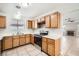 Well-lit kitchen features wooden cabinets, stainless steel appliances, and an open layout to the adjacent living room at 239 Eugene Way, Henderson, NV 89015