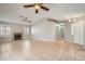 Bright living room with tile flooring, fireplace, neutral paint, and two ceiling fans for added comfort at 239 Eugene Way, Henderson, NV 89015