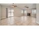 Open-concept living room featuring tile floors, a fireplace, ceiling fans, and access to the backyard at 239 Eugene Way, Henderson, NV 89015