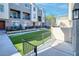 Artificial grass in the backyard of a multi-story unit with a metal fence at 2843 Kona Blue Ln # 4, Las Vegas, NV 89183