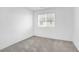 Bright, carpeted bedroom with a large window at 2843 Kona Blue Ln # 4, Las Vegas, NV 89183