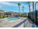 Relaxing community hot tub with palm trees in a fenced outdoor area at 2843 Kona Blue Ln # 4, Las Vegas, NV 89183