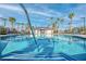 Resort-style community pool with palm trees and comfortable lounge seating at 2843 Kona Blue Ln # 4, Las Vegas, NV 89183